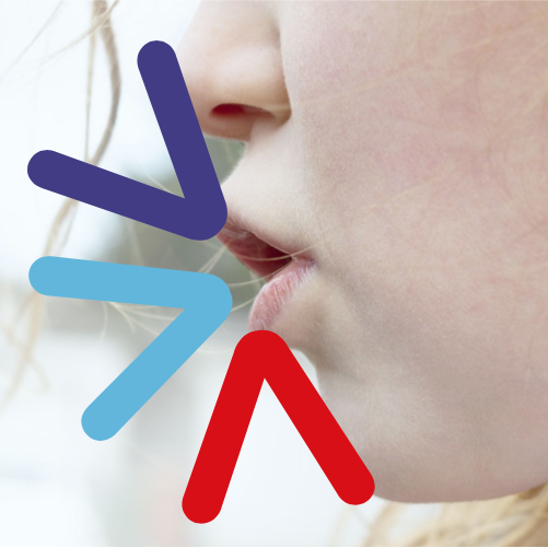 A photo of a child's side profile as they speak, with > symbols emerging from their mouth in different colours.