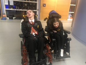 Two children sit in wheelchairs.