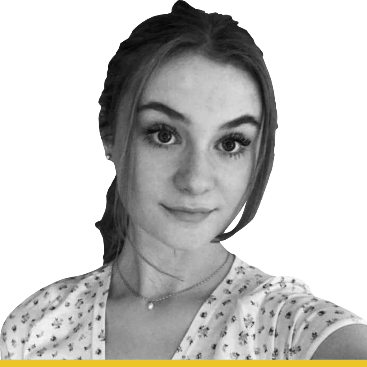 Black and white headshot of young woman with long straight brown hair that is tied up, with fringe around her face. She is wearing a white floral t-shirt and necklace.