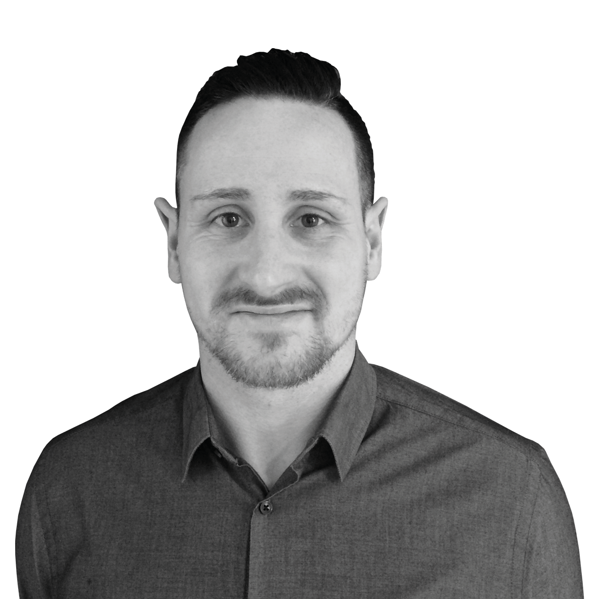 A black and white image of a man looking at the camera from the chest up. He has short brown hair and is wearing a dark shirt.