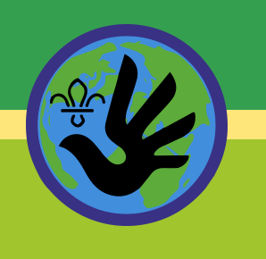 A Scouts circular badge of the earth in blue and green, with a dark blue outline. In the middle the Scouts logo is in black, along with an icon of an outstretched hand. The background is two shades of green with a yellow banner through the centre