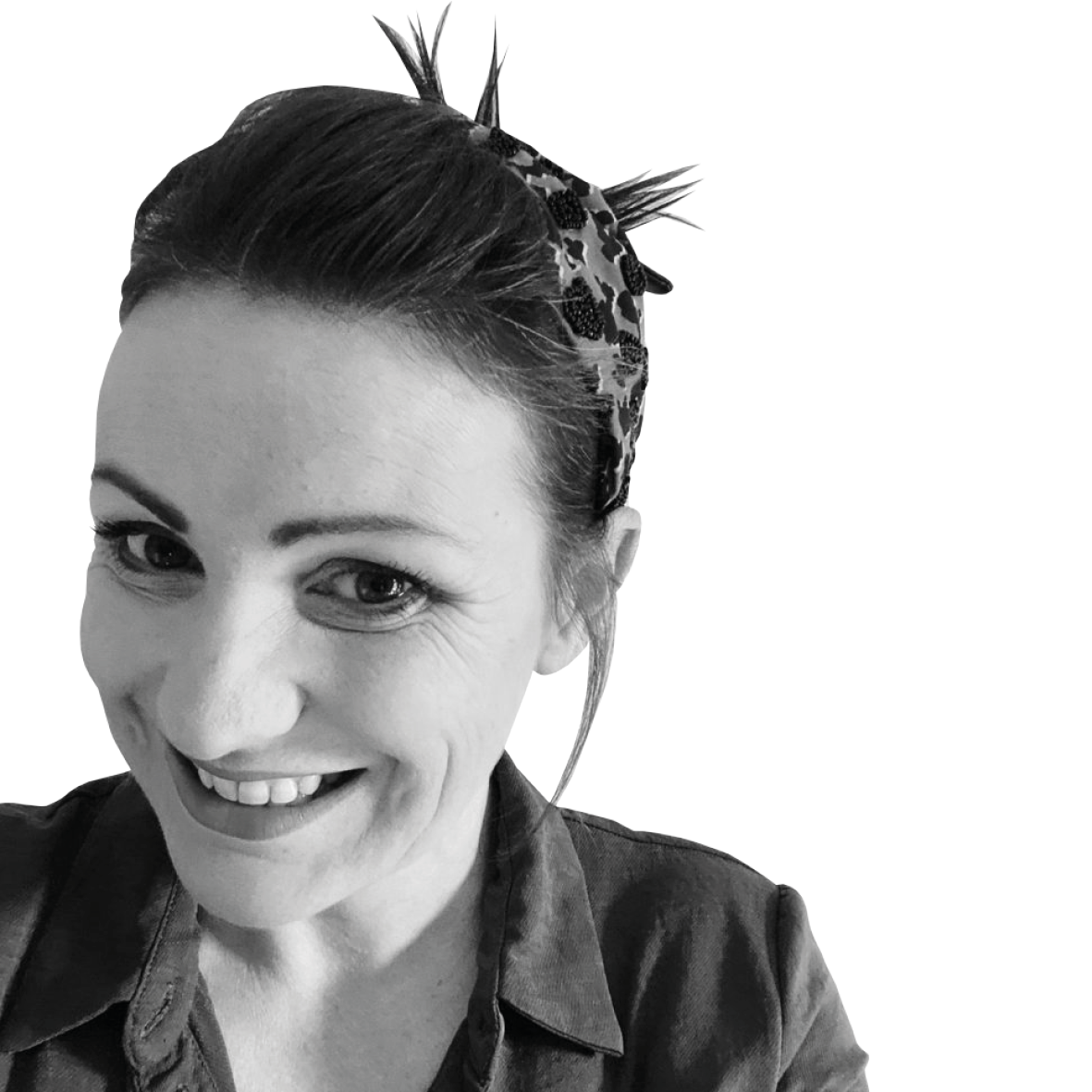 Greyscale headshot of a woman smiling at the camera, on a white background.