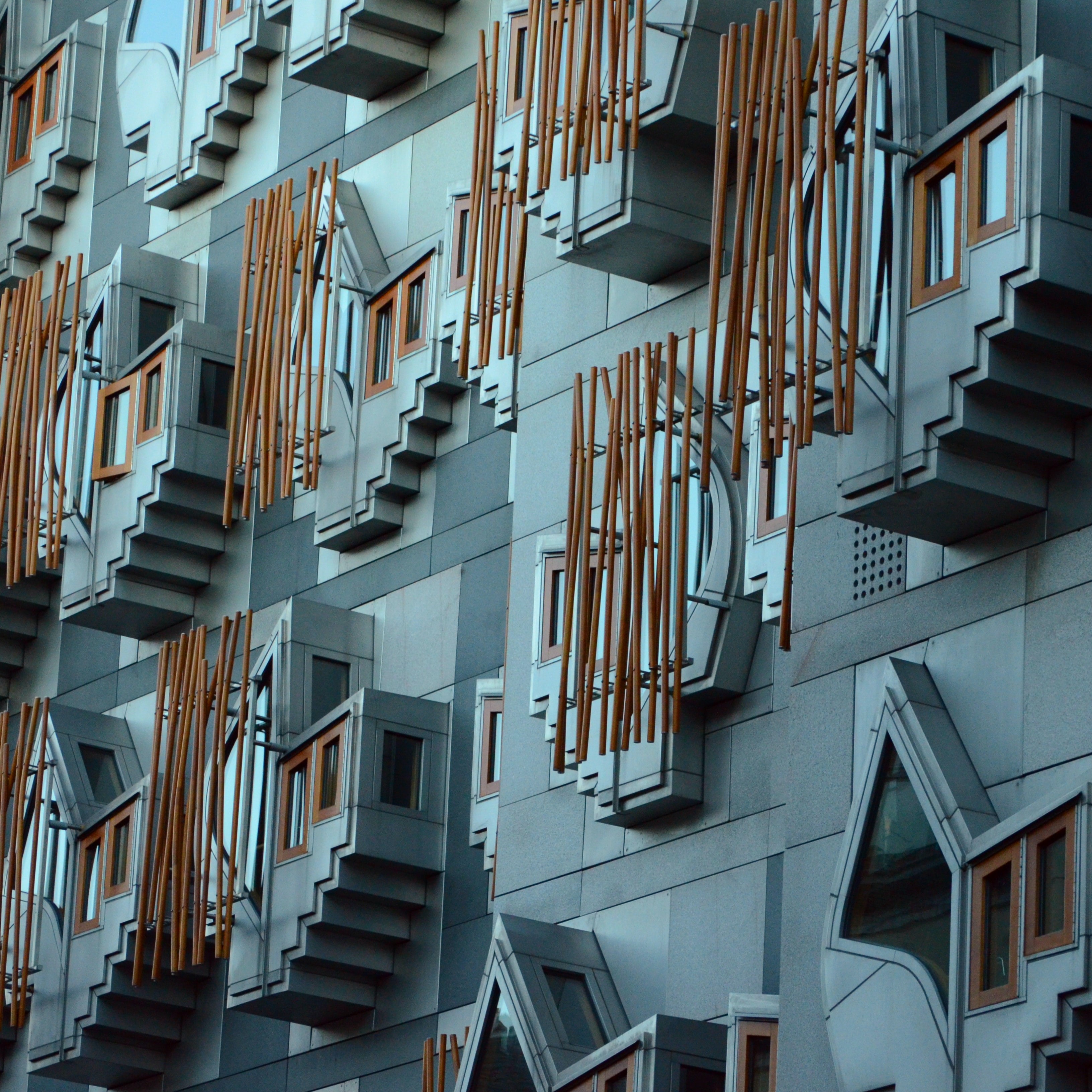 A close-up of Holyrood's exterior windows, with grey bricks and wooden decoration and protruding stone features