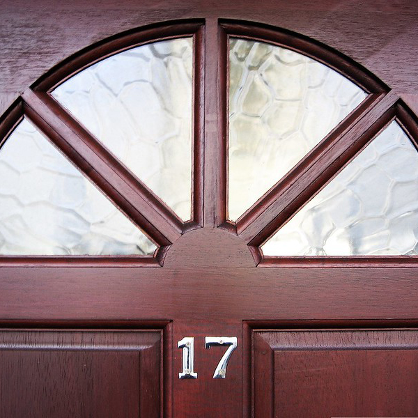 Brown front door with number 17 and glass windows