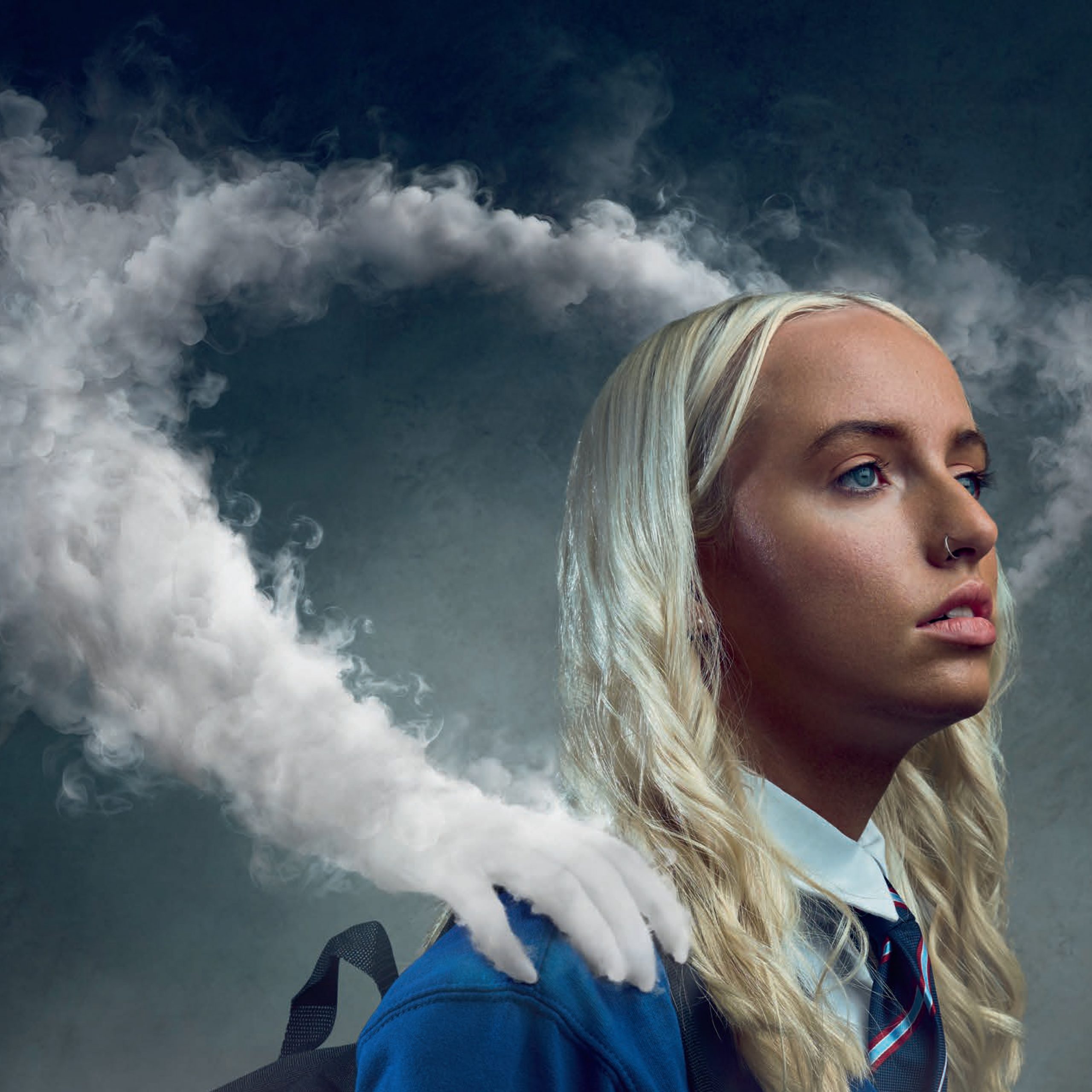 Taken from a Scottish Government campaign poster, the image features a young person with blonde hair. They are wearing a generic school uniform and a hand, make of vape smoke, is touching their shoulder