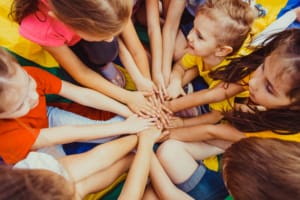Lots of children's hands together in a circle
