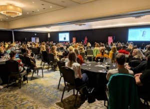 Juliet Harris of Together addresses a packed and engaged crowd at AC25