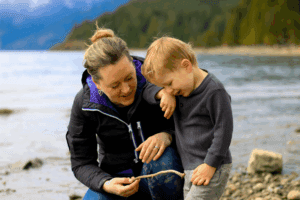 Young boy at the beach with his mother