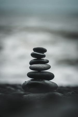 Stones piled into a tower on a beach in a zen-like fashion
