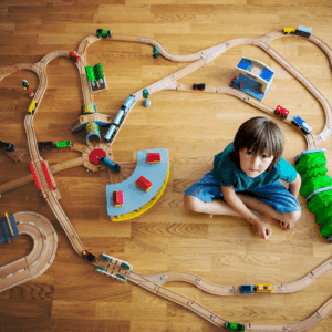 Young boy with a wooden train set
